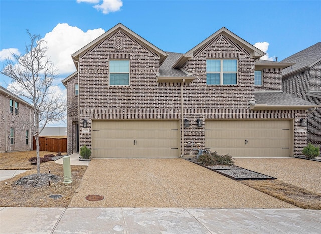 traditional-style home featuring driveway, brick siding, an attached garage, and a shingled roof