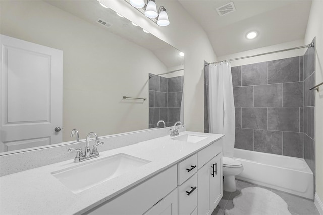 bathroom with toilet, a sink, and visible vents