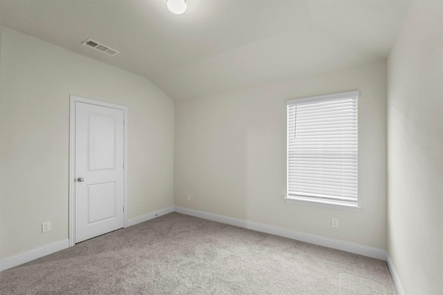 empty room featuring carpet floors, visible vents, and baseboards