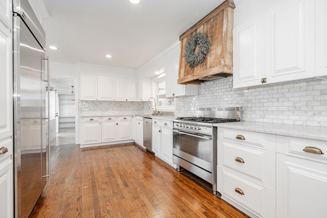 1265 S Main St, Jacksboro, TX 76458 - kitchen with high end appliances, decorative backsplash, crown molding, a sink, and light stone countertops