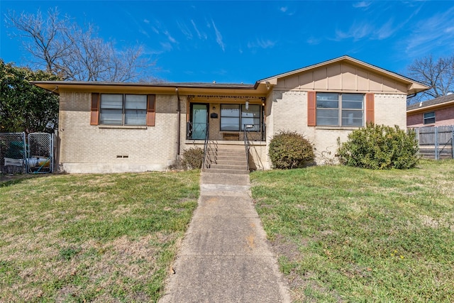 single story home featuring crawl space, brick siding, fence, and a front lawn