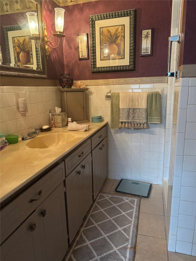 bathroom with tile patterned flooring, a wainscoted wall, vanity, and tile walls