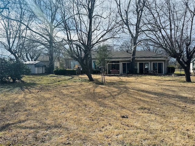 view of yard featuring an outbuilding and a shed