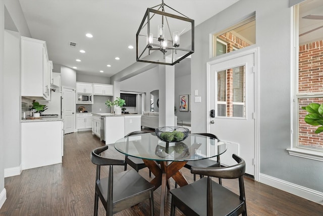 dining area with dark wood-style floors, visible vents, recessed lighting, and baseboards