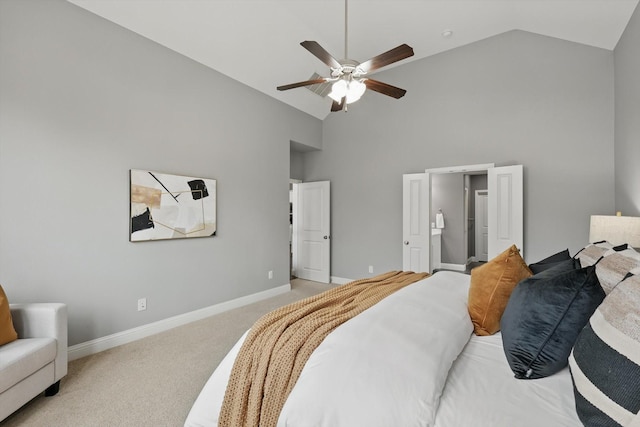 bedroom with baseboards, high vaulted ceiling, ceiling fan, light carpet, and connected bathroom