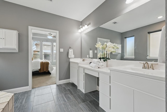 full bathroom featuring a sink, visible vents, baseboards, and double vanity