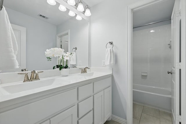 full bath with visible vents, double vanity, a sink, shower / bath combination, and tile patterned floors