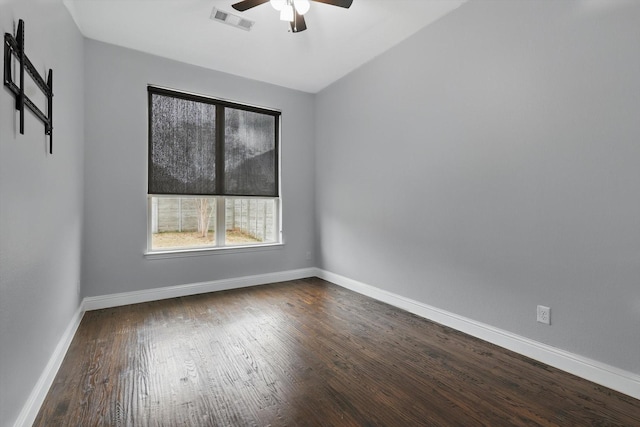 empty room featuring visible vents, a ceiling fan, baseboards, and wood finished floors