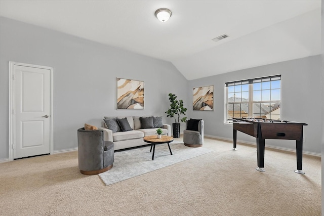 carpeted living area featuring visible vents, baseboards, and lofted ceiling