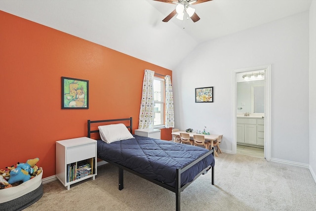 carpeted bedroom featuring ensuite bath, lofted ceiling, a ceiling fan, and baseboards