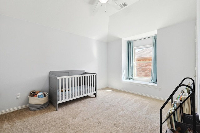 bedroom featuring baseboards, visible vents, carpet floors, lofted ceiling, and ceiling fan