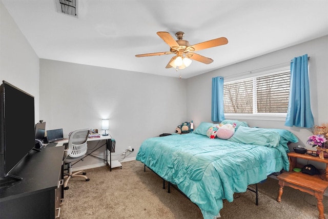 carpeted bedroom featuring visible vents, baseboards, and a ceiling fan