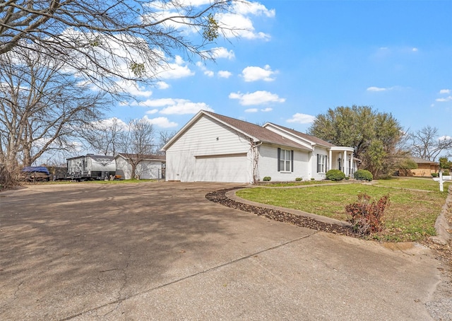 view of home's exterior featuring a garage, driveway, and a yard