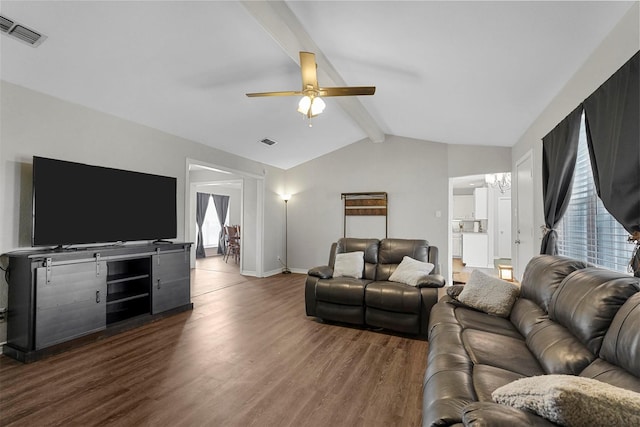 living area featuring visible vents, vaulted ceiling with beams, wood finished floors, and a ceiling fan