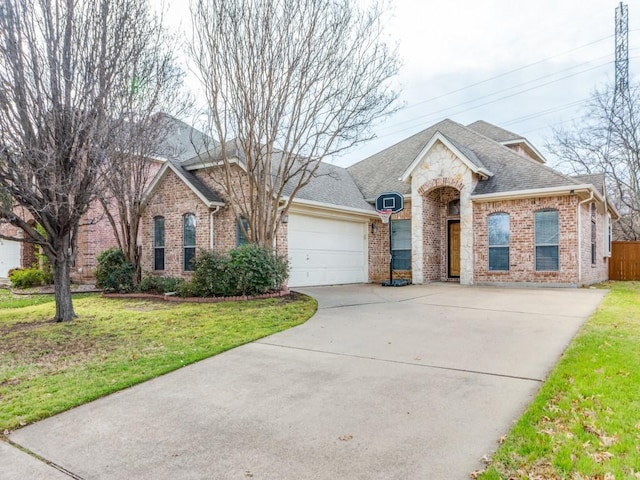 view of front of property featuring a garage, brick siding, and a front lawn