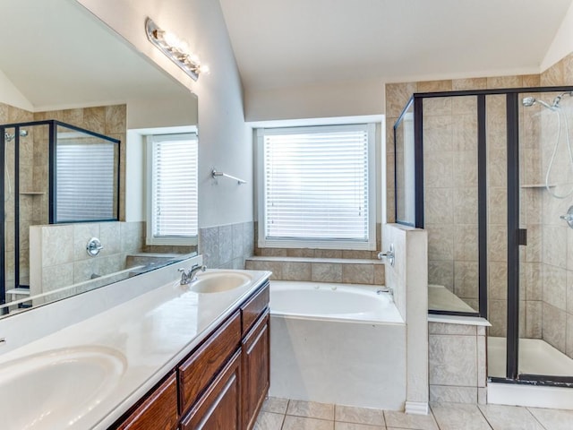 full bathroom with vaulted ceiling, a sink, and a shower stall