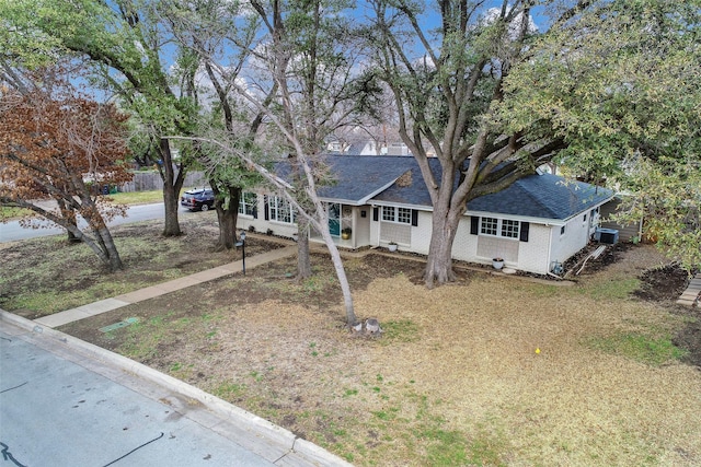 ranch-style house featuring driveway, a shingled roof, and brick siding