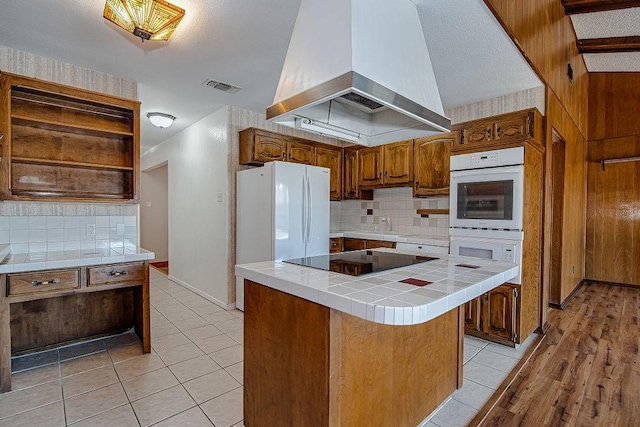 kitchen with open shelves, tile counters, visible vents, ventilation hood, and white appliances