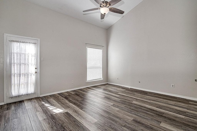 unfurnished room with dark wood-style floors, plenty of natural light, a ceiling fan, and baseboards