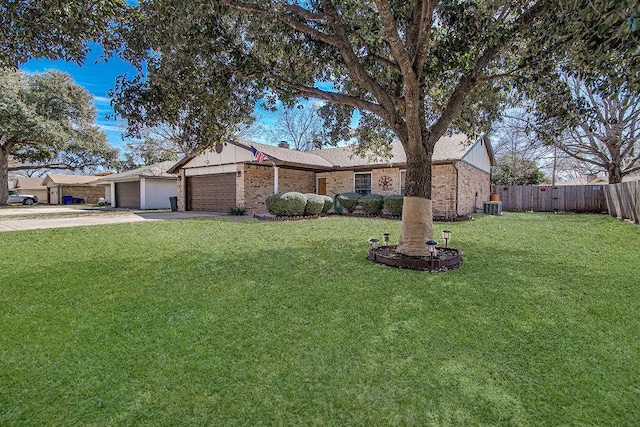 ranch-style house with brick siding, an attached garage, fence, and a front yard