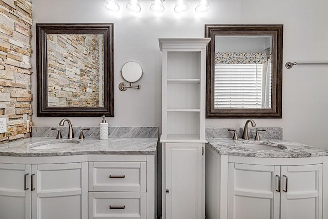 bathroom featuring two vanities and a sink