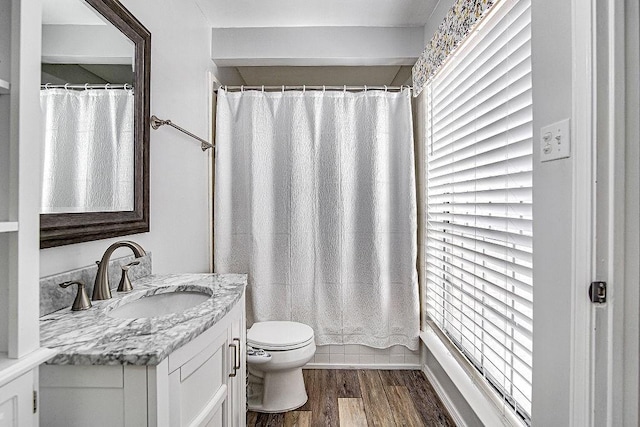 full bathroom featuring a shower with curtain, vanity, toilet, and wood finished floors