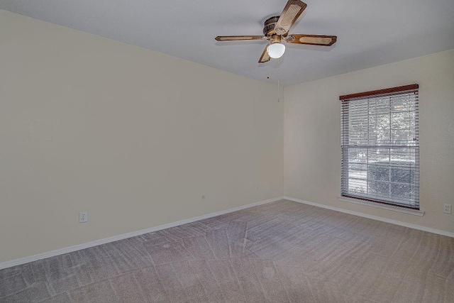 unfurnished room featuring light carpet, a ceiling fan, and baseboards