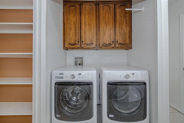 washroom featuring washer and dryer and cabinet space