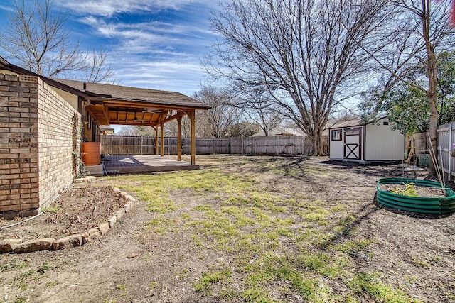 view of yard with a storage shed, a fenced backyard, a patio, and an outbuilding