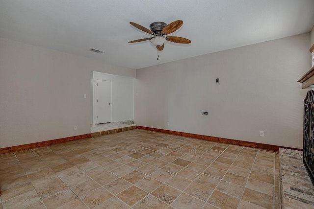 unfurnished room featuring ceiling fan, visible vents, and baseboards