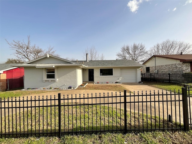 view of front of property featuring a fenced front yard, brick siding, driveway, and an attached garage