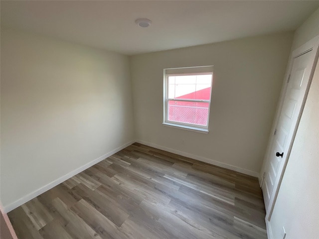 unfurnished bedroom with baseboards and wood finished floors