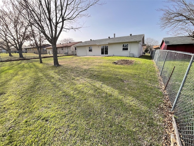 exterior space featuring fence and a lawn