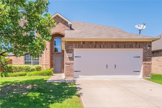 view of front of home featuring a garage, brick siding, driveway, and a front lawn