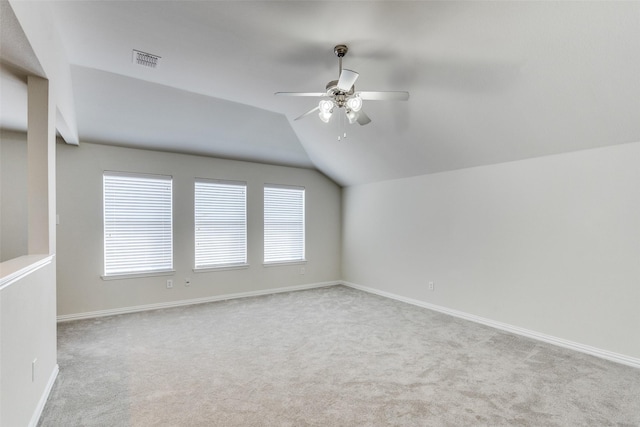 additional living space with visible vents, carpet flooring, ceiling fan, and vaulted ceiling