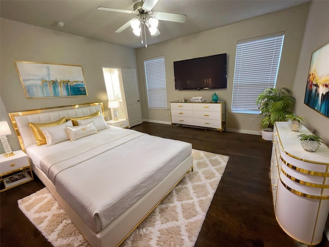 bedroom featuring a ceiling fan, baseboards, and wood finished floors