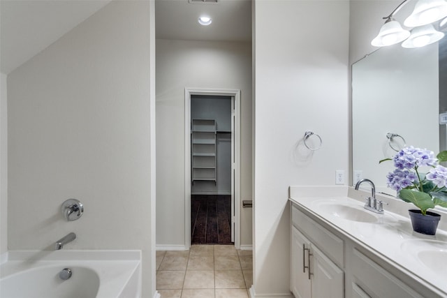 full bathroom featuring tile patterned flooring, visible vents, double vanity, a bath, and a sink