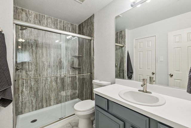 full bath featuring toilet, a stall shower, marble finish floor, and vanity