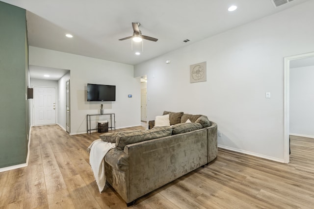 living area with light wood-style floors, recessed lighting, visible vents, and baseboards