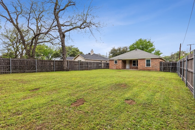 view of yard with a fenced backyard