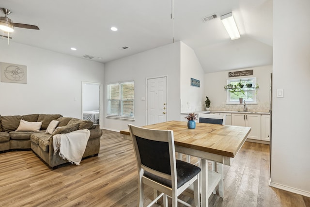 dining area with ceiling fan, light wood-style flooring, plenty of natural light, and visible vents