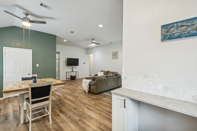 interior space with light wood finished floors, lofted ceiling, recessed lighting, visible vents, and a ceiling fan