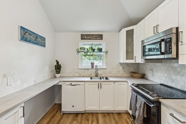 kitchen with lofted ceiling, white dishwasher, a sink, black electric range oven, and stainless steel microwave