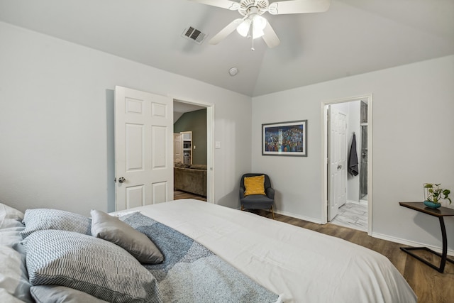 bedroom with baseboards, visible vents, a ceiling fan, lofted ceiling, and wood finished floors