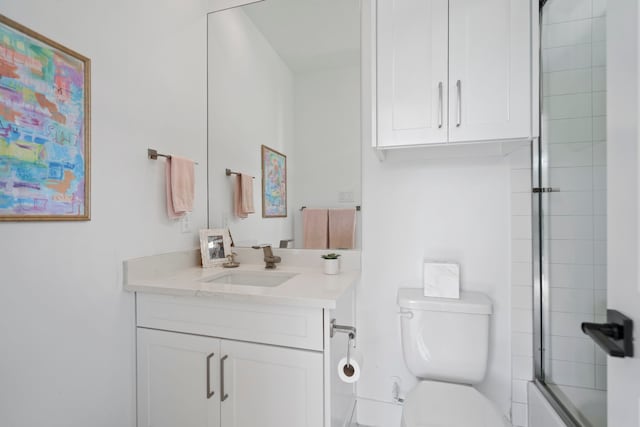 full bath featuring bath / shower combo with glass door, vanity, and toilet