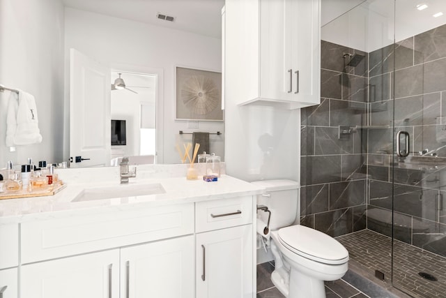 full bathroom featuring visible vents, toilet, a stall shower, ceiling fan, and vanity