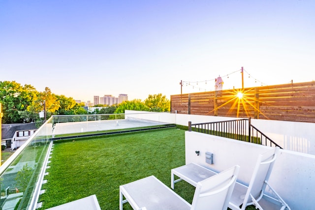 view of yard featuring fence and a city view