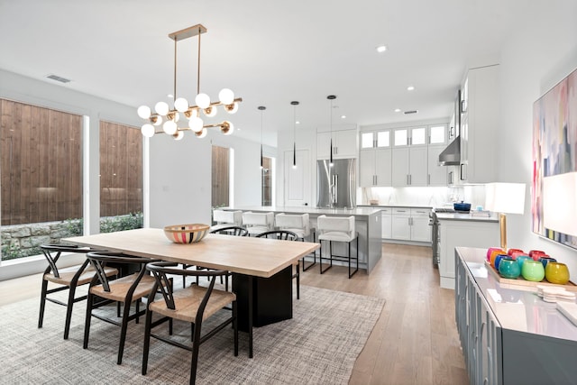 dining room with light wood-style floors, recessed lighting, visible vents, and a notable chandelier