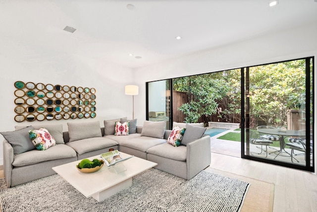 living room with wood finished floors and recessed lighting