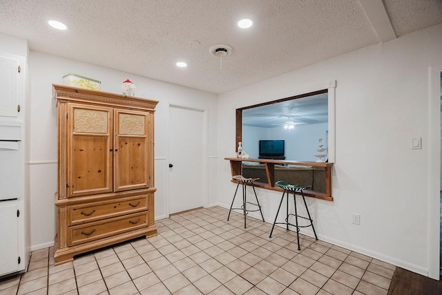 home office featuring recessed lighting, baseboards, and a textured ceiling